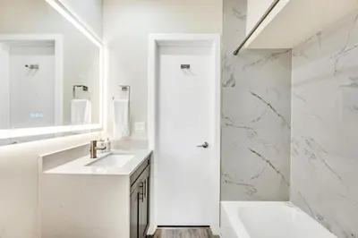 a white bathroom with a sink and a shower at Waterfront Heated pool Lime Key Two in Fort Lauderdale