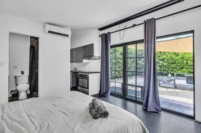 a bedroom with a bed and a large window at Family Vacation Home in Miami