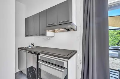 a kitchen with stainless steel appliances and a sink at Family Vacation Home in Miami