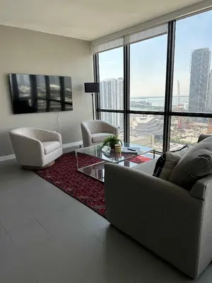 a living room with a couch and a glass table at Luxury 2BR Skyline Balcony Free Parking by Palermo Home Miami in Miami