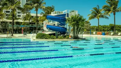 a slide in a pool at a resort at Residence Inn by Marriott Miami Beach Surfside in Miami Beach