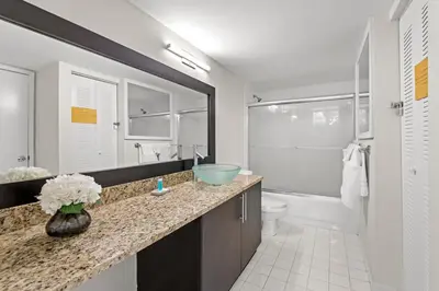 a bathroom with a sink and a toilet and a mirror at Yacht Club Miami Suite 1BR and 1BA with Pool FREE Parking Gym & Jacuzzi in South Island