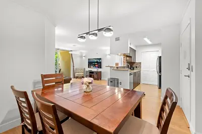 a kitchen and dining room with a wooden table and chairs at Yacht Club Miami Suite 1BR and 1BA with Pool FREE Parking Gym & Jacuzzi in South Island