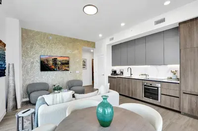 a kitchen and living room with a couch and a table at 72 Park by Nomada Residences in Miami Beach