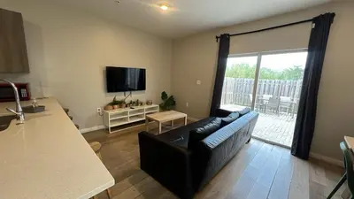 a living room with a couch and a large window at Family Comfort Near Top Spots-Relaxing Stay for Everyone in Golden Glades