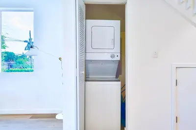 a kitchen with a washer and dryer in a room at Family Comfort Near Top Spots-Relaxing Stay for Everyone in Golden Glades