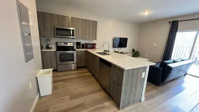 a kitchen with a sink and a stove top oven at Family Comfort Near Top Spots-Relaxing Stay for Everyone in Golden Glades