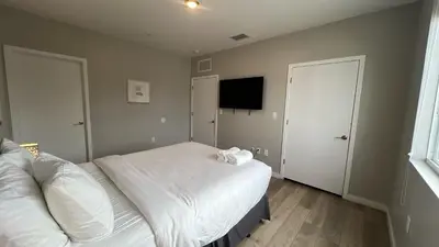 a bedroom with a bed and a flat screen tv at Family Comfort Near Top Spots-Relaxing Stay for Everyone in Golden Glades