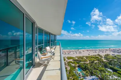 an ocean view from the balcony of a hotel with a beach at The Setai Miami Private Luxury Residences in Miami Beach