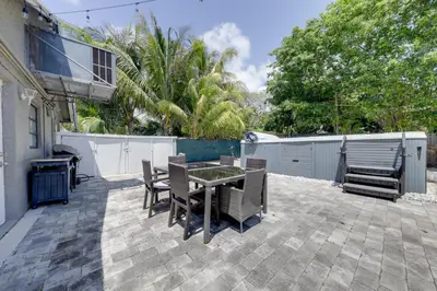 a patio with a table and chairs and a fence at Unique 2 House Rental 3 Mi to Beach and Boardwalk in Hollywood
