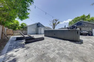 a patio with two benches and a building at Unique 2 House Rental 3 Mi to Beach and Boardwalk in Hollywood