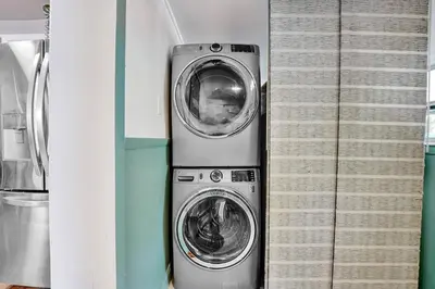 two washing machines sitting next to each other at Heated Saltwater Pool Family & Pet-Friendly Oasis in Fort Lauderdale