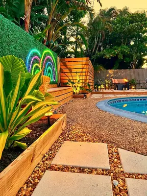 a backyard with a pool and a colorful fence at Heated Saltwater Pool Family & Pet-Friendly Oasis in Fort Lauderdale