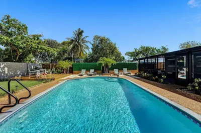 a swimming pool in the backyard of a house at Heated Saltwater Pool Family & Pet-Friendly Oasis in Fort Lauderdale