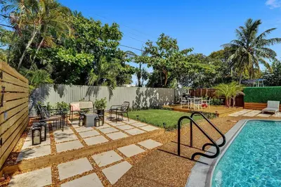 a backyard with a swimming pool and a patio at Heated Saltwater Pool Family & Pet-Friendly Oasis in Fort Lauderdale