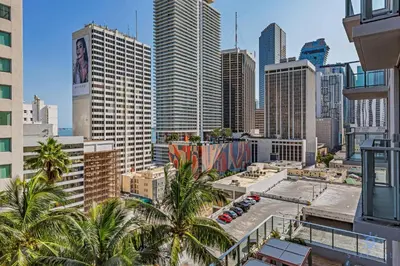 a city skyline with palm trees and buildings at Beautiful 2BR Apartment with gym and Pool in Miami