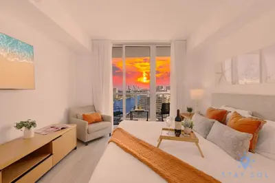 a living room with a couch and a table at Stylish -2BR Apartment -Balcony & Pool in Hallandale Beach