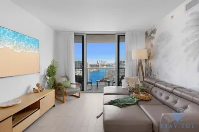 a living room with a couch and a table at Amazing 1BR Apt View & Balcony - Pool & Gym in Hallandale Beach