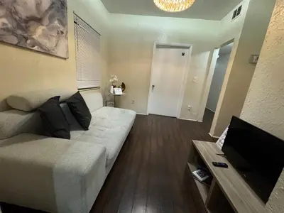 a living room with a couch and a flat screen tv at Belle Vista in Miami