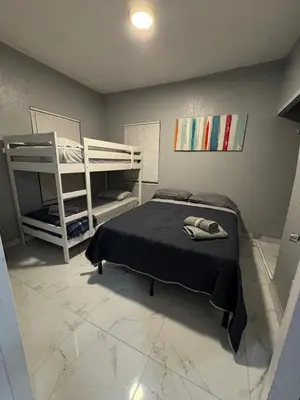 a bedroom with a bed and a bunk bed and a ladder at Belle Vista in Miami