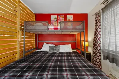 two bunk beds in a bedroom with red walls at 1BR Pet-Friendly Studio Parking & Backyard BBQ in Hollywood