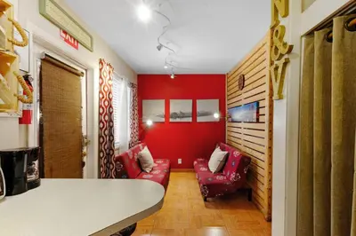 a living room with red walls and red chairs at 1BR Pet-Friendly Studio Parking & Backyard BBQ in Hollywood