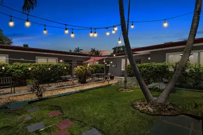 a backyard with a palm tree and lights at Pet-Friendly 1BR Studio w/ Parking & BBQ, Hollywood in Hollywood