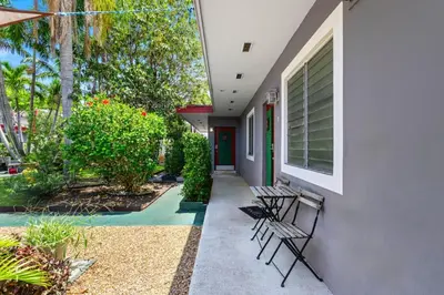a porch of a house with chairs and plants at 1BR Studio Parking, BBQ, Garden In Hollywood in Hollywood
