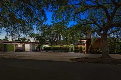 a house with a tree on the side of a street at Modern 1BR Studio in Hollywood | Free Parking in Hollywood