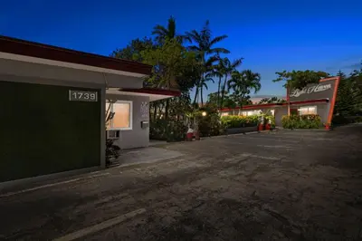 an empty parking lot in front of a gas station at Bright 2BR Getaway | BBQ, Garden & Parking in Hollywood