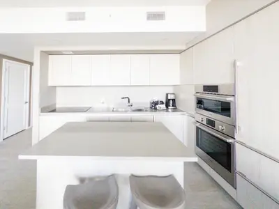 a white kitchen with a sink and a stove at 3 BDR Beach Bliss in Hollywood