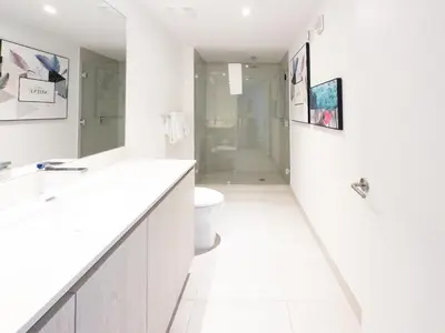 a white bathroom with a toilet and a sink at 3 BDR Beach Bliss in Hollywood