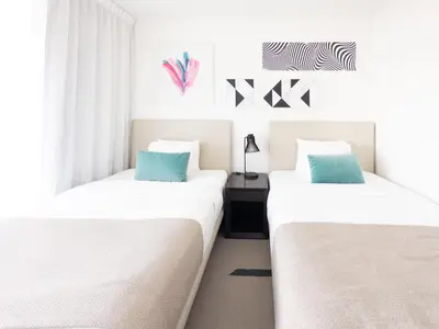 two beds sitting next to each other in a room at 3 BDR Beach Bliss in Hollywood