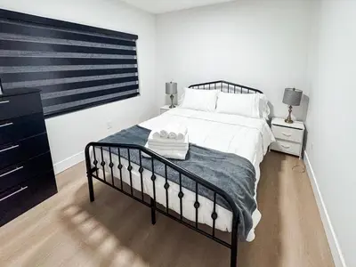 a bedroom with a bed and a dresser at Miami Freedom Park Oasis by H&S in Miami