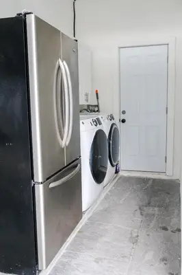a kitchen with a refrigerator and a washer and dryer at Miami Freedom Park Oasis by H&S in Miami