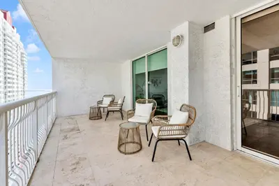 a patio with chairs and tables on a balcony at Luxury3 Miami Brickell Stay-Bay View in Miami