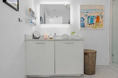 a white bathroom with a sink and a mirror at Midblock Midtown Miami 1B W Spa Pool Gym in Miami