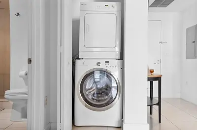 a washer and dryer in a bathroom with a toilet at Midblock Midtown Miami 1B W Spa Pool Gym in Miami