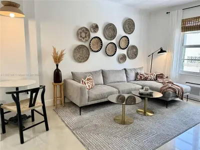 a living room with a couch and plates on the wall at Contemporary chic, next to the beach - 1 Bedroom in Miami Beach