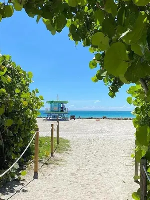 a view of a beach with a boat in the distance at Contemporary chic, next to the beach - 1 Bedroom in Miami Beach