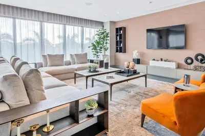 a living room with a couch and a tv at Stylish Studio with Pool View at the Heart of Downtown Doral in Miami