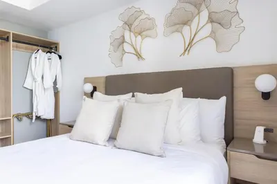 a bedroom with a large bed with white pillows at Downtown Miami 2BR-2BA Panoramic City Views in Miami