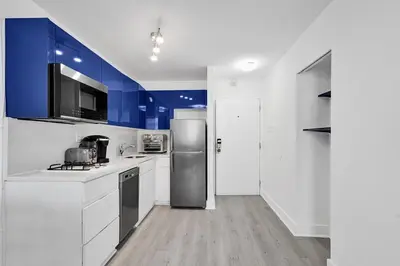 a kitchen with white counters and a stainless steel refrigerator at Ocean Dr 1BR • Miami Beach Getaway in Miami Beach