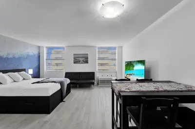 a bedroom with a bed and a desk and a couch at Ocean Dr 1BR • Miami Beach Getaway in Miami Beach