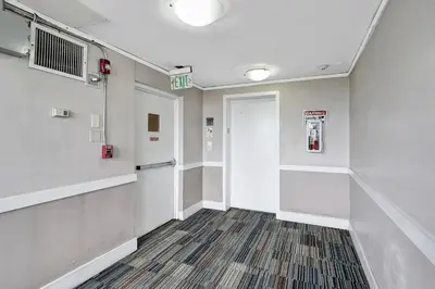 a hallway of a hospital with a door and a hallway at Ocean Dr 1BR • Miami Beach Getaway in Miami Beach
