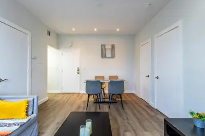 a living room with a couch and a table at Coastal 2BR Escape | Walk to Beach & 2 Queen Beds in Miami Beach