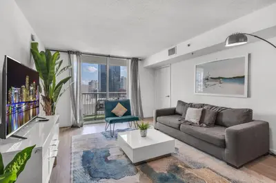 a living room with a couch and a tv at Enjoy Brickell Living 2 BR Retreat With Free Parking in Miami