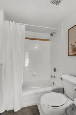 a white bathroom with a toilet and a bath tub at Enjoy Brickell Living 2 BR Retreat With Free Parking in Miami