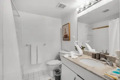 a white bathroom with a toilet and a sink at Enjoy Brickell Living 2 BR Retreat With Free Parking in Miami