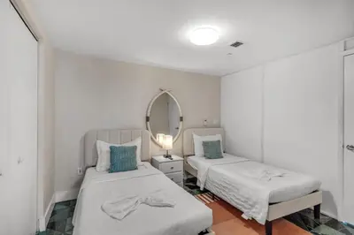 a bedroom with two beds and a mirror at Icon Brickell Gem 2-BR Oasis with Amazing Views in Miami